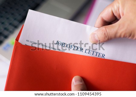 Job offer letter in red envelope. A man get an offer with hiring for working. Royalty-Free Stock Photo #1109454395