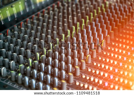 Detail with adjusting knobs on a professional audio mixer and music equipment for sound mixer control, electronic device