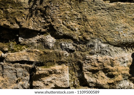 Old stone brick walls of natural stone with dust cobweb and mud textured background