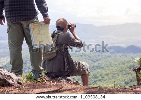 Male hikers use binoculars to watch the scenery, Holiday activities, Pictures with space for editing.