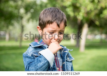Handsome little boy crying excited in the park