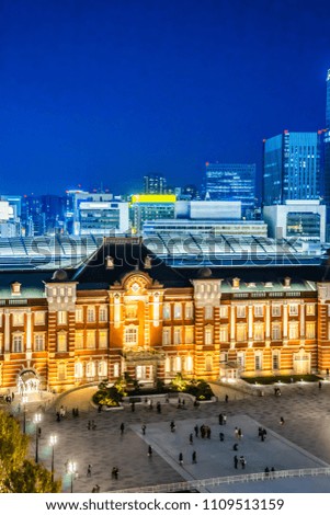 Asia Business concept for real estate and corporate construction - panoramic urban city skyline aerial view and tokyo station under twilight sky and neon night in tokyo, Japan