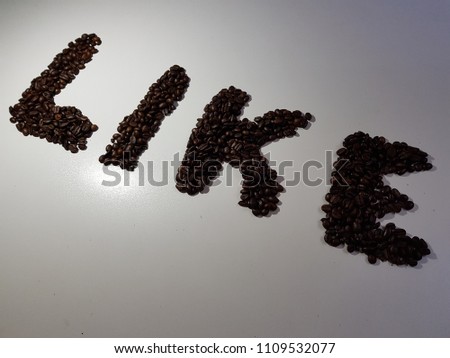 The word "LIKE" made of roasted coffee bean, isolated on white background