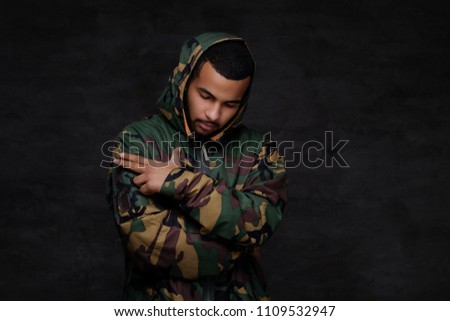 Handsome African-American guy wear military jacket.