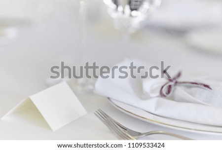 Ornate table, name card with purple ribbon and place for your text.