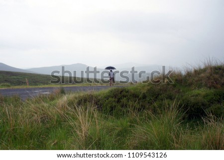 Umbrella, photographer and drizzle in the Wicklow Mountain.Ireland.