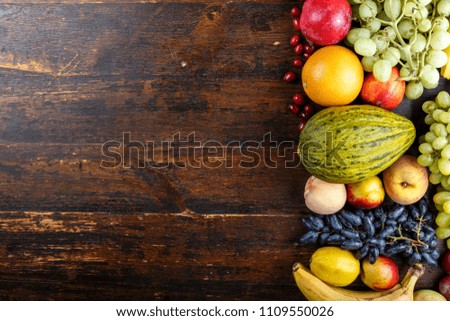 fruit background with exotic fruits on a brown wooden background, fruit detox, space for text