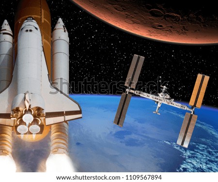 Rocket flies from earth to Mars. Space station in the distance. The elements of this image furnished by NASA.
