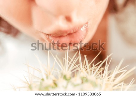 Woman kissing a cactus