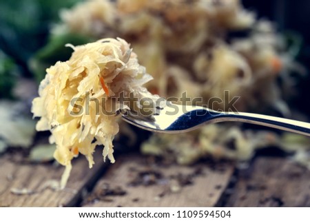 Sauerkraut on a fork with a shallow depth of field. Pickling cabbage at home. The best natural probiotic. Royalty-Free Stock Photo #1109594504
