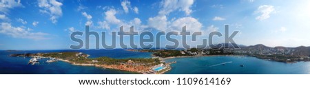 Aerial drone bird's eye view panoramic ultra wide 180 degrees photo of iconic Astir beach and Peninsula with beautiful scattered clouds, Vouliagmeni, Athens riviera, Attica, Greece
