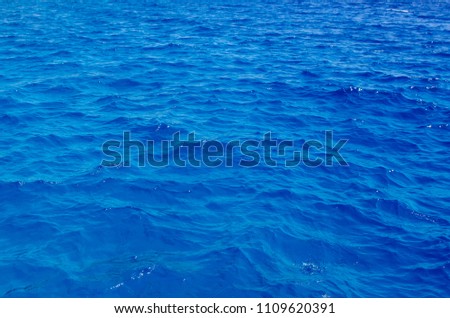 a piece of beautiful red sea close-up. The deep blue color of the sea. Background from sea water