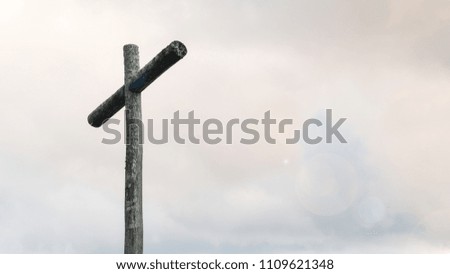 Wood cross on blue sky and copy space. Christian background, spiritual scene.