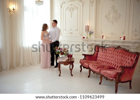young romantic couple dancing on their date in big empty room