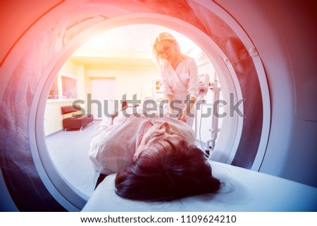 Doctor and patient in the room of computed tomography at hospital. Medical equipment. Royalty-Free Stock Photo #1109624210