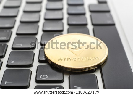 Ethereum cryptocurrency. the gold coin lies on the keyboard