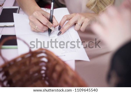 women's hand holding a glass of champagne on the background of the festive table