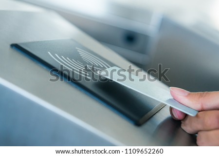 Hand holding Blue Card to access Electronic Entrance Scanner, Security Technology