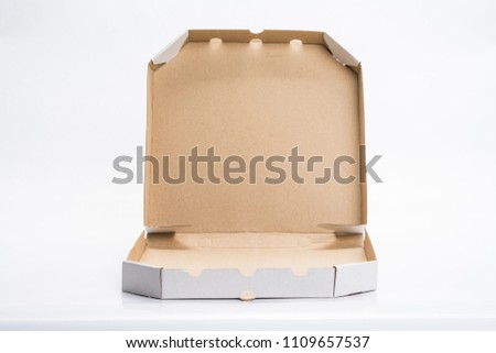 Blank cardboard paper box isolated on abstract blurred white background.