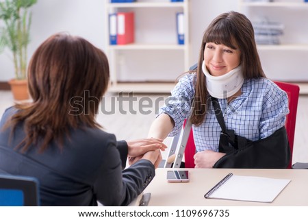 Injured employee visiting lawyer for advice on insurance Royalty-Free Stock Photo #1109696735