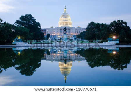 Washington DC, US Capitol Building in a cloudy sunrise with mirror reflection Royalty-Free Stock Photo #110970671