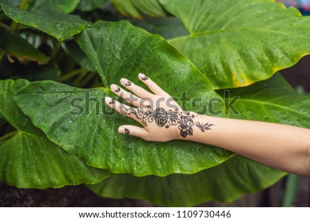 Picture of human hand decorated with henna Tattoo. mehendi hand.