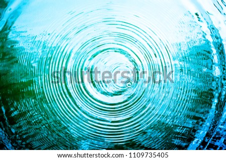 Top view Closeup blue water rings, Circle reflections in pool. Royalty-Free Stock Photo #1109735405