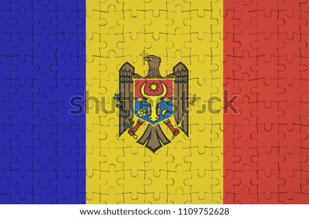 Moldova flag  is depicted on a folded puzzle