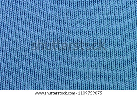 The texture of the fabric in blue color. Material for making shirts and blouses