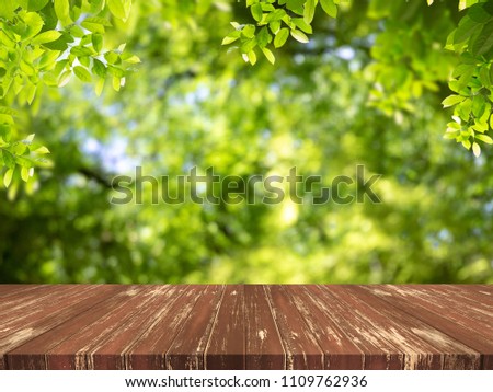 Empty wood table top with Green nature background.For product display