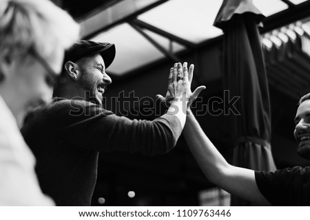 Friends giving a high five Royalty-Free Stock Photo #1109763446