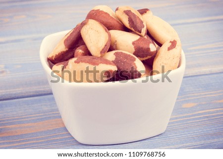 Vintage photo, Heap of brazil nuts in glass dish as source of natural minerals and vitamin, healthy nutrition concept