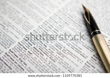 fountain pen and open dictionary Royalty-Free Stock Photo #1109770385