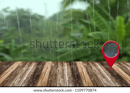 Map pin location button on wooden table over rainy day, Map pointer navigation concept