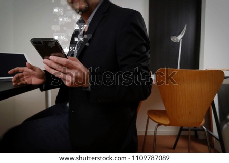 Social media and Marketing virtual icons screen concept.businessman working with smart phone and digital tablet and laptop computer in modern office