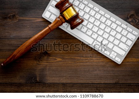 Work desk of contemporary lawyer. Lawyer office concept. Judge gavel near computer keyboard on dark wooden background top view space for text