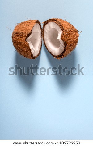 Broken in half the coconut on blue background