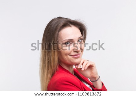Smiling freckled beautiful woman with hand on her chin