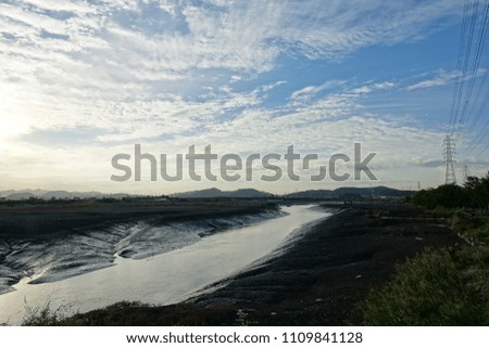 mud flat at ebb tide, against blue sky