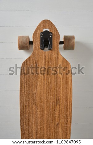 wood pattern drop through type pintail longboard on a white deck background