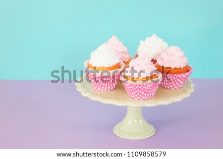 Decorative birthday cupcaces on cake stand