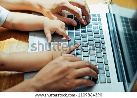 Asian father and his son is using the laptop computer at their home on sunday or holiday. Royalty-Free Stock Photo #1109864390
