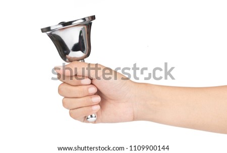 hand holding silver hand bell isolated on a white background. Royalty-Free Stock Photo #1109900144