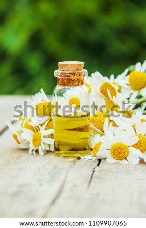 Chamomile extract in a small bottle. Selective focus. 