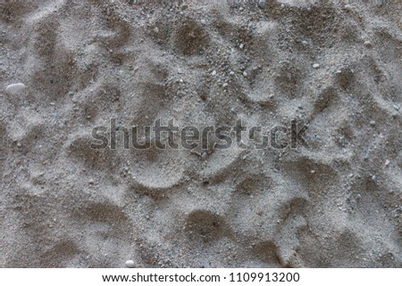 Picture of sand on a beach with some small stones