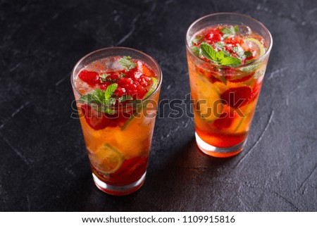 Strawberry mojito cocktail with berries, lime, mint and ice. Summer berry cocktail