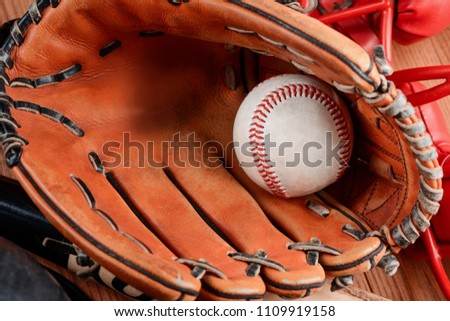 Detailed view on leather mitt glove and ball. Baseball equipment for catching a pitch.