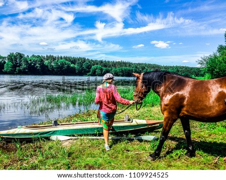 Woman with horse by the river