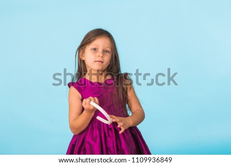 cute cheerful little girl portrait, isolated on blue background