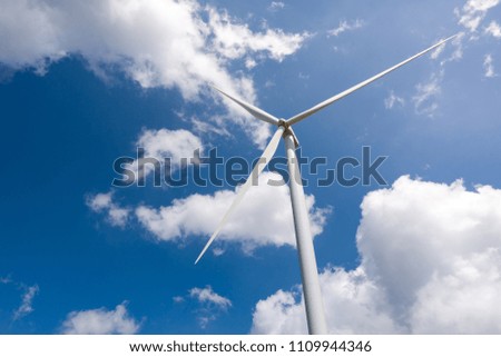 sustainable renewable energy large 3 blades wind turbine generate electrical power and supply to the city. (picture of single tower with clouds and blue sky background)